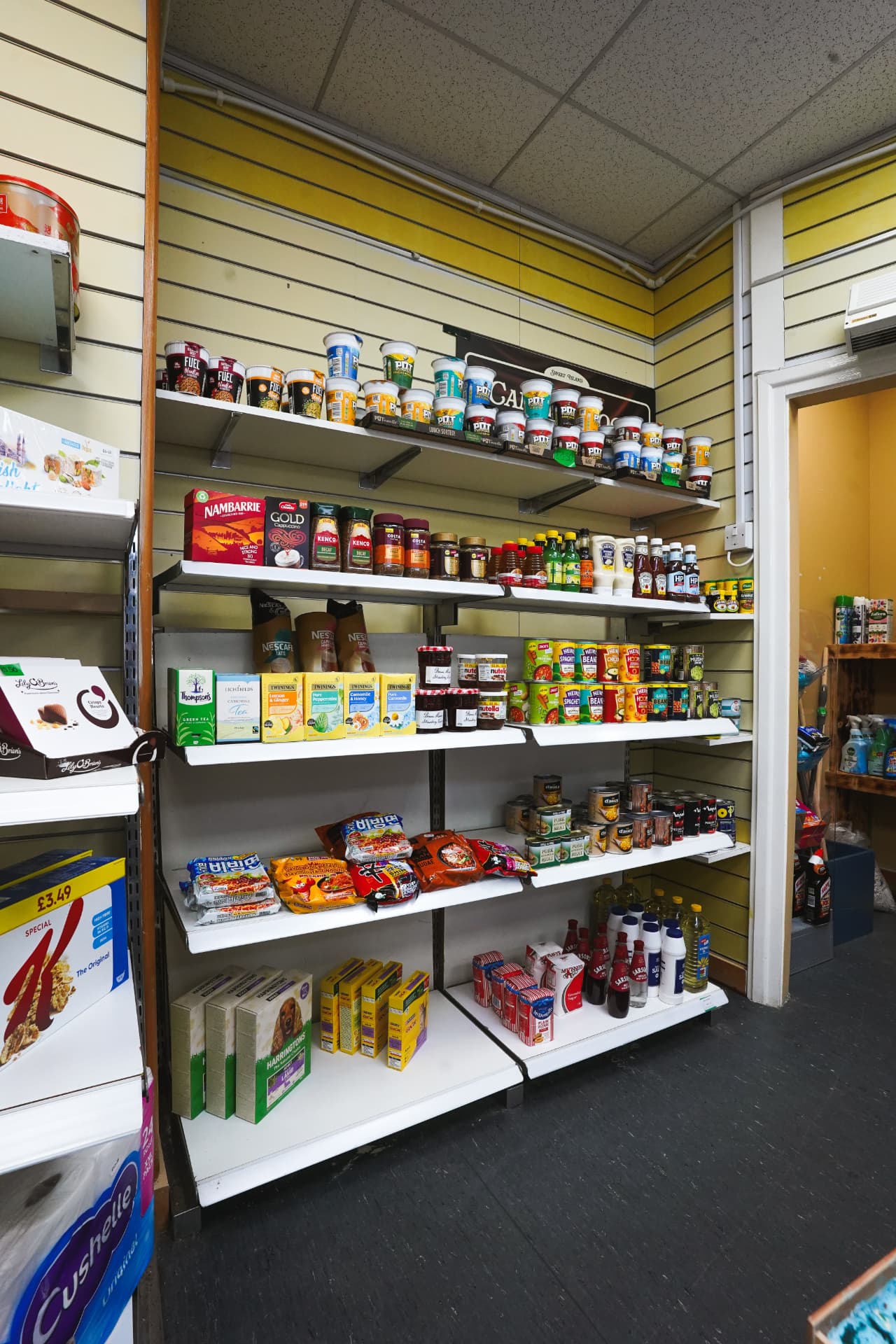 Grocery shelves with tea, coffee, jars and tins